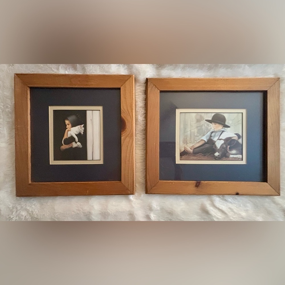 Two framed Amish Children prints by American artist Nancy N.A. Noel.